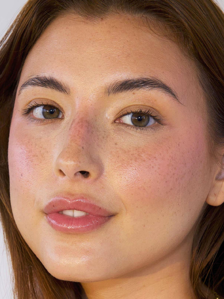 close up of model wearing blush & PROTECT SPF 50+